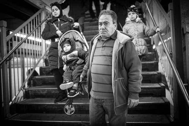 Hassan Ferdous carries his grandson, also named Hassan, with Eman.