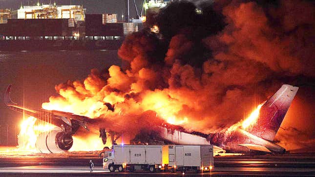 This photo provided by Jiji Press shows a Japan Airlines plane on fire on a runway of Tokyo's Haneda Airport on January 2, 2024.