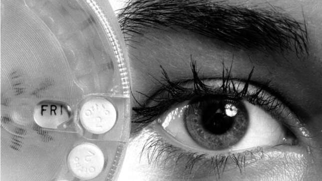 A woman holds a birth control pill dispenser indicating the day of the week in New York in August 1974. 