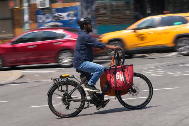 FILE - A delivery worker rides a motorized bicycle, July 25, 2023, in New York. On Monday, Nov. 13, New York City officials said that retailers and food delivery companies must do more to halt the proliferation of unsafe e-bike and e-scooter batteries after a fire blamed on an electric scooter&#39;s lithium ion battery killed three people over the weekend. (AP Photo/Seth Wenig, File)