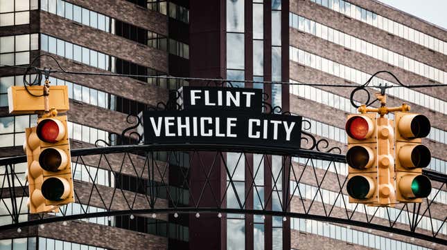 A downtown gateway sign showing Vehicle City in Flint, Michigan.