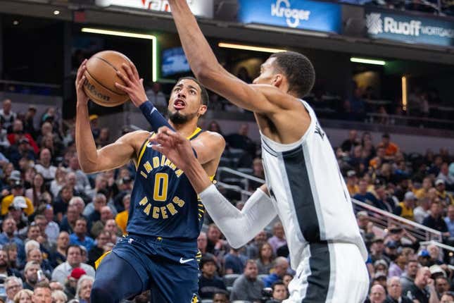 Nov 6, 2023; Indianapolis, Indiana, USA; Indiana Pacers guard Tyrese Haliburton (0)  shoots the ball while San Antonio Spurs center Victor Wembanyama (1) defends in the first half at Gainbridge Fieldhouse.