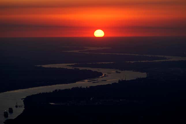 FILE - Ships travel along the Mississippi River in LaPlace, La., as the sun sets on Oct. 20, 2023. The nation’s rivers and streams remain stubbornly polluted with nutrients that can contaminate drinking water, degrade aquatic life and feed the so-called “dead zone” in the Gulf of Mexico, according to a recently released Environmental Protection Agency assessment. (AP Photo/Gerald Herbert, File)