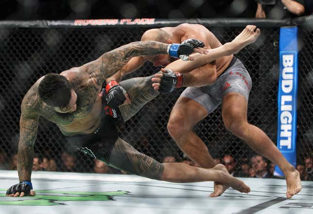 FILE - In this Sept. 9, 2017, file photo, ILir Latifi, right, of Sweden, takes down Tyson Pedro, of Australia, during their mixed martial arts bout at UFC 215 in Edmonton, Alberta. Bud Light is set to return as the official beer of UFC in the U.S. next year. Under a new multi-year marketing deal between UFC and Bud Light maker Anheuser-Busch, the brewer will become the mixed martial arts organization&#39;s “Official Beer Partner” in the U.S. starting Jan. 1, per a joint announcement on Tuesday, Oct. 24, 2023. (Jason Franson/The Canadian Press via AP, File)