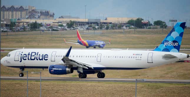 FILE - A Jet Blue jetliner taxis down a runway as a Southwest Airlines airliner takes off from Denver International Airport Tuesday, July 5, 2022, in Denver. Shares of JetBlue are rising more than 15% before the market open on Tuesday, Feb. 13, 2024, as activist investor Carl Icahn took an almost 10% stake in the airline. (AP Photo/David Zalubowski, File)