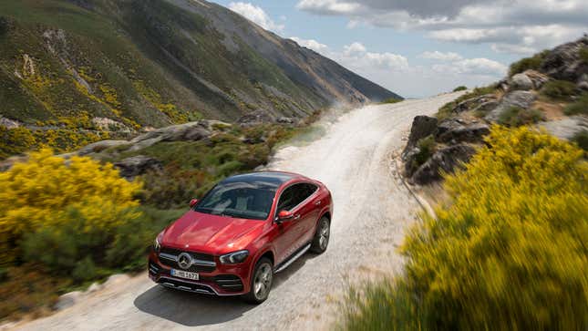 A red Mercedes GLE Coupe driving on a mountain road