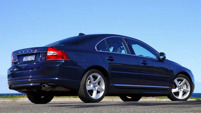 A photo of a dark blue Volvo S80 sedan. 