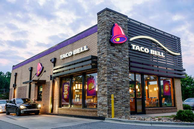 A Taco Bell restaurant and drive thru at dusk in Gastonia, North Carolina.