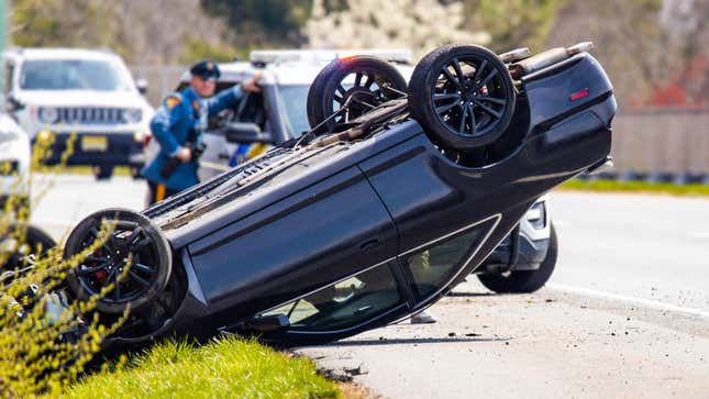 Vehicle rollover highway road accident with police in the back