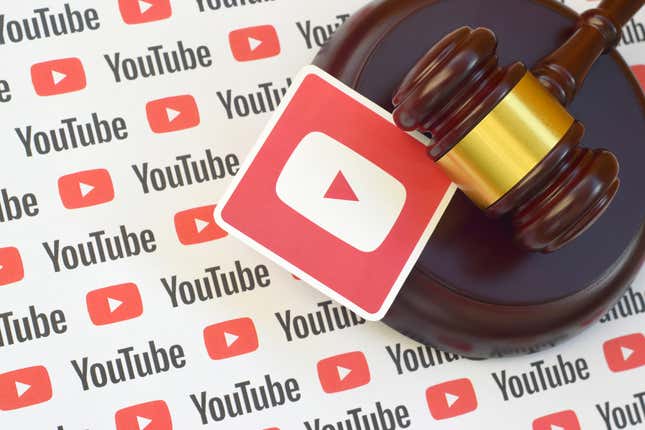 A gavel on top of the youtube logo.
