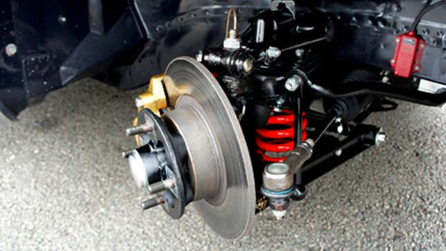 A close up photo of the spring in a car's front suspension. 