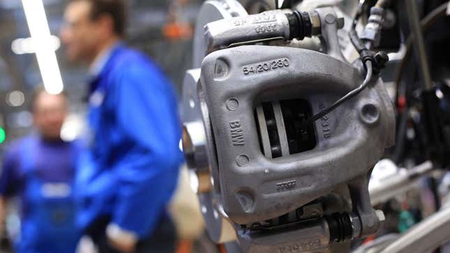 A photo of a front brake caliper on a car. 