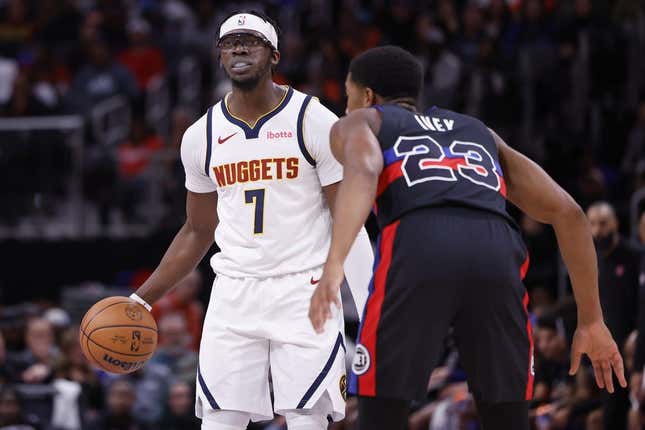 Nov 20, 2023; Detroit, Michigan, USA;  Denver Nuggets guard Reggie Jackson (7) dribbles defended by Detroit Pistons guard Jaden Ivey (23) in the first half at Little Caesars Arena.