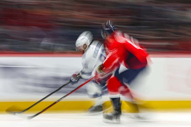 WASHINGTON, DC - DECEMBER 23: Nikita Kucherov #86 of the Tampa Bay Lightning skates with the puck past Joel Edmundson #6 of the Washington Capitals during the first period at Capital One Arena on December 23, 2023 in Washington, DC. (Photo by Patrick Smith/Getty Images)