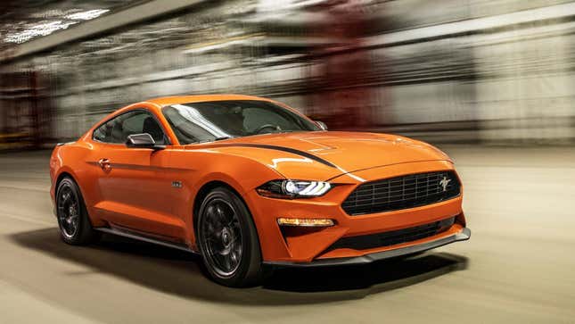 A photo of an orange Ford Mustang. 