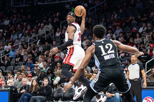 Nov 11, 2023; Atlanta, Georgia, USA; Miami Heat center Bam Adebayo (13) saves the ball from going out of bounds against Atlanta Hawks forward De&#39;Andre Hunter (12) during the first quarter at State Farm Arena.