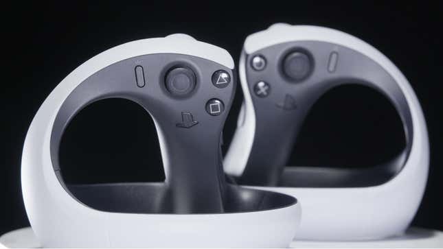 Two PS VR2 controllers sit at a distance from one another in front of a black background.
