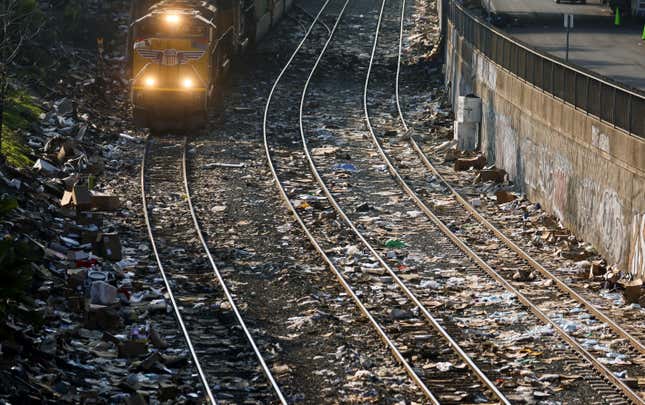 Union Pacific freight train passes a section of littered rail tracks in Los Angeles