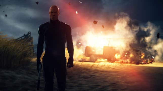 Agent 47 walks away from an explosion in Hitman 2.