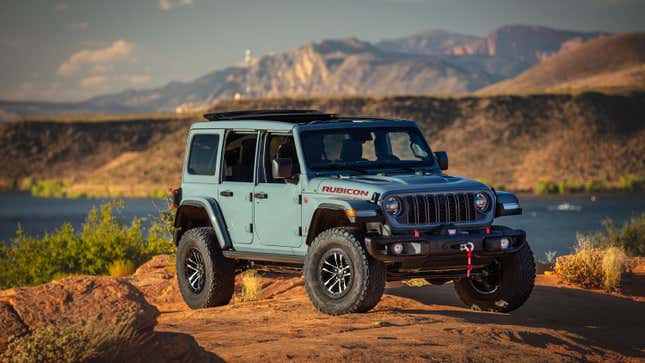 A Jeep Wrangler Rubicon atop a rocky hill.