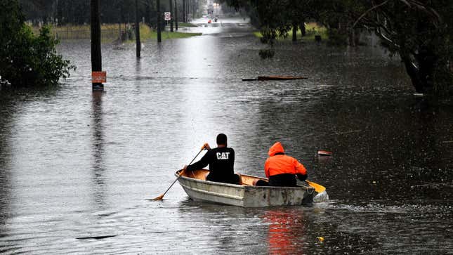 Residents commute on a boat in a flooded residential area near Windsor, Australia.