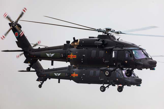 Z-20 helicopters fly during The 5th China Helicopter Exposition at Free Trade Zone of Tianjin Port on October 10, 2019 in Tianjin, China.