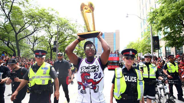  Kyle Lowry of the Toronto Raptors walks down the street with the NBA Championship trophy during the Toronto Raptors victory parade on June 17, 2019, in Toronto. Some 1 million people turned out for the celebration, which was marred when gunshots rang out leaving four people hurt. Police arrested three.