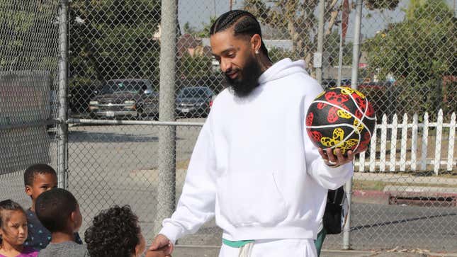 Nipsey Hussle greets kids at the Nipsey Hussle x PUMA Hoops Basketball Court Refurbishment Reveal Event on October 22, 2018 in Los Angeles, California. 