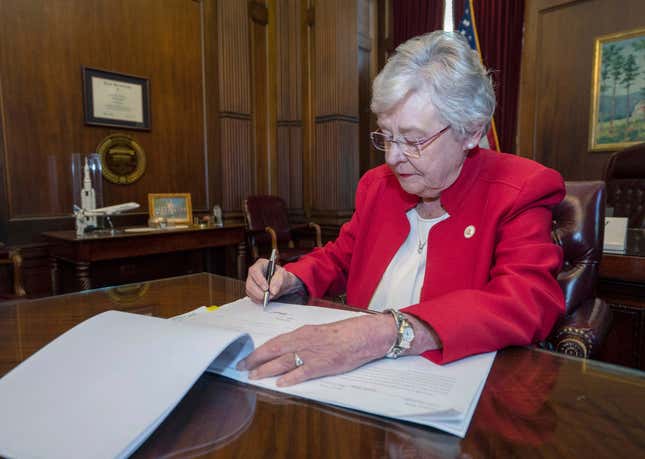 Alabama Gov. Kay Ivey signing a bill that virtually outlaws abortion in the state on Wednesday, May 15, 2019, in Montgomery, Ala.