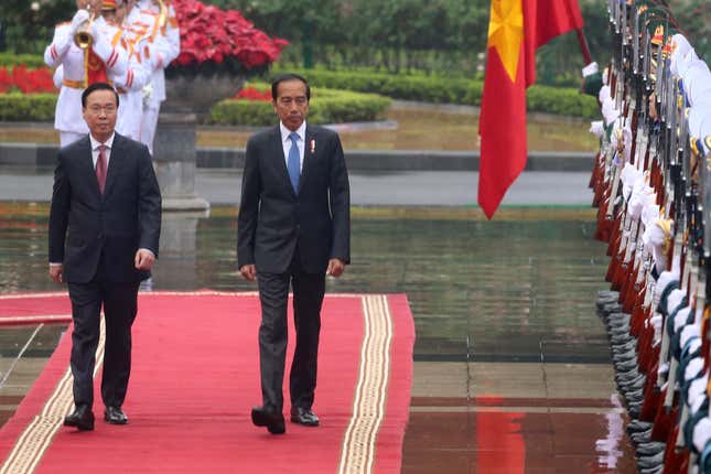 Vietnamese President Vo Van Thuong, left, and Indonesian President Joko Widodo inspect honor guards in Hanoi, Vietnam on Friday, Jan. 12, 2024. Widodo is on a three-day visit to Hanoi to boost the bilateral relation with the fellow Southeast Asian nation. (AP Photo/Huy Han)