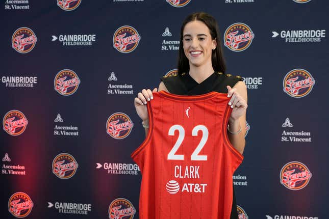 Indiana Fever&#39;s Caitlin Clark holds her jersey following a WNBA basketball news conference, Wednesday, April 17, 2024, in Indianapolis. (AP Photo/Darron Cummings)