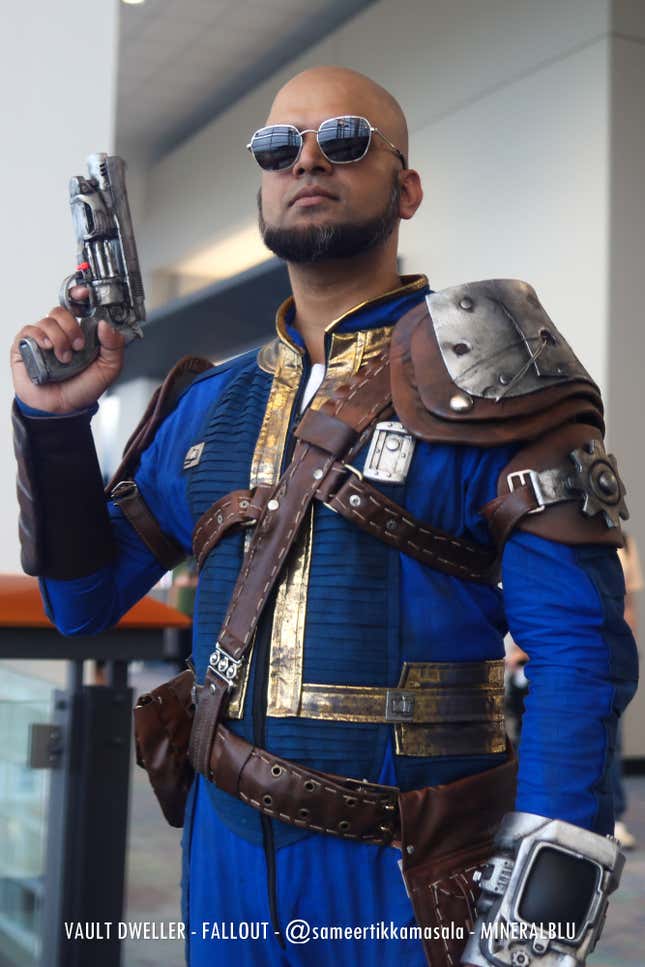 A vault dweller wields a gun. 