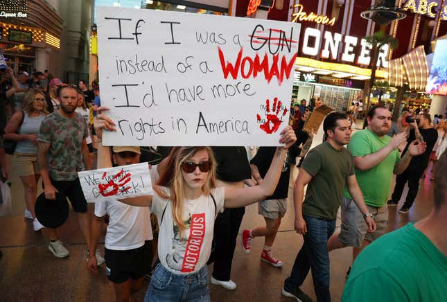 Aly Smith (C) marches along Fremont Street Experience as abortion rights  activists protest after the overturning of Roe Vs. Wade by the US  Supreme Court, in Las Vegas, Nevada on June 24, 2022. 