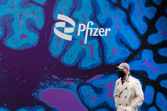 FILE - A man walks by Pfizer headquarters, Friday, Feb. 5, 2021, in New York. Pfizer reports their earnings on Tuesday, Jan. 30, 2024. (AP Photo/Mark Lennihan, File)