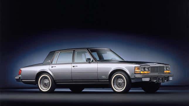 A photo of a two-tone Cadillac Seville in a studio. 