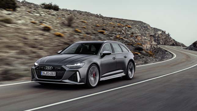 A front 3/4 shot of a gray Audi RS6 Avant driving around a bend on a curvy road