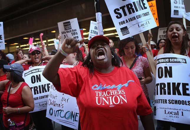 Chicago public school teachers and their supporters picket in front of the Chicago Public Schools (CPS) headquarters on September 11, 2012, in Chicago, Illinois. More than 26,000 teachers and support staff walked off their jobs yesterday after the Chicago Teachers Union failed to reach an agreement with the city on compensation, benefits, and job security. 