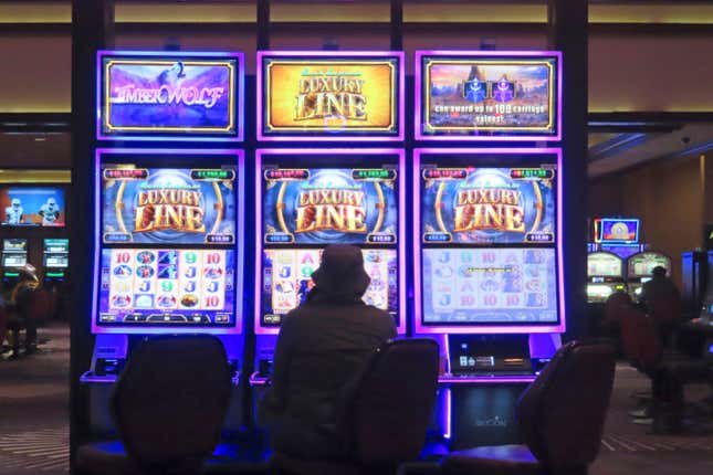 A gambler plays a slot machine at Harrah&#39;s casino in Atlantic City, N.J. on Sept. 29, 2023. On Jan, 16, 2023, New Jersey gambling regulators released statistics showing that Atlantic City&#39;s casinos, racetracks that accept sports betting and their online partners won nearly $5.8 billion from gamblers in 2023, a new record. But only three of the nine casinos won more from in-person gamblers last year than they did in 2019 before the coronavirus pandemic broke out. (AP Photo/Wayne Parry)