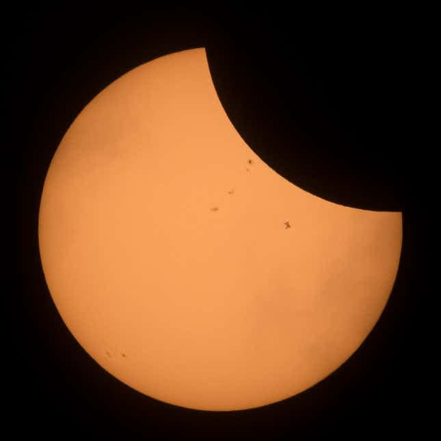 The International Space Station, with a crew of six onboard, is seen in silhouette as it transits the Sun at roughly five miles per second during a partial solar eclipse on Aug. 21, 2017 near Banner, Wyoming.