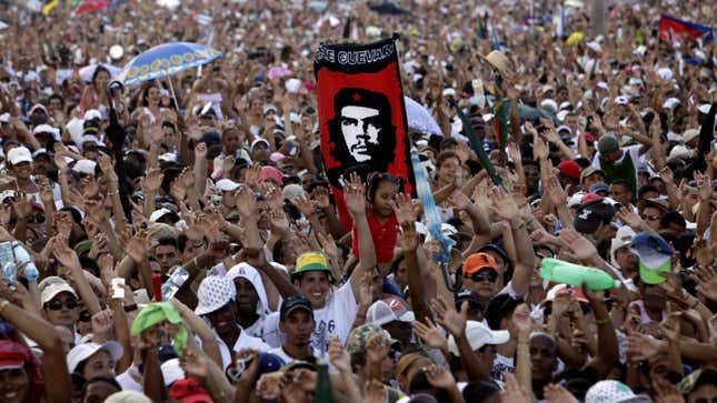  In this file photo, a person holds a banner of Che Guevara at the Peace Without Borders concert in  Revolution Square in Havana, Cuba on Sept. 20, 2009. 