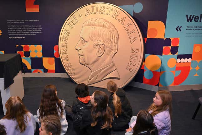 School children look at a large mock up of a new coin at The Royal Australian Mint in Canberra, Thursday, Oct. 5, 2023. An image of King Charles III will soon appear on Australian coins more than a year after the death of his mother Queen Elizabeth II, officials said. (Mick Tsikas/AAP Image via AP)