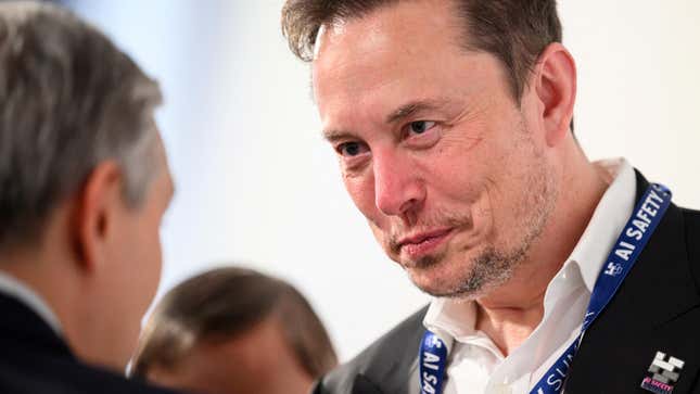 Tesla, X (formerly known as Twitter) and SpaceX's CEO Elon Musk speaks with other delegates on Day 1 of the AI Safety Summit at Bletchley Park in Bletchley, Britain on November 1, 2023.