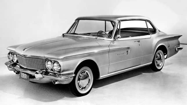 A black and white photo of a Dodge Lancer. 