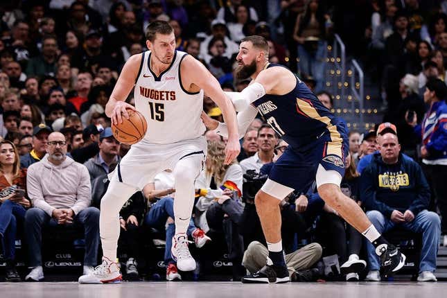 Nov 6, 2023; Denver, Colorado, USA; Denver Nuggets center Nikola Jokic (15) controls the ball as New Orleans Pelicans center Jonas Valanciunas (17) guards in the second quarter at Ball Arena.