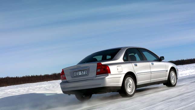 A photo of a silver Volvo S80 sedan driving over ice. 