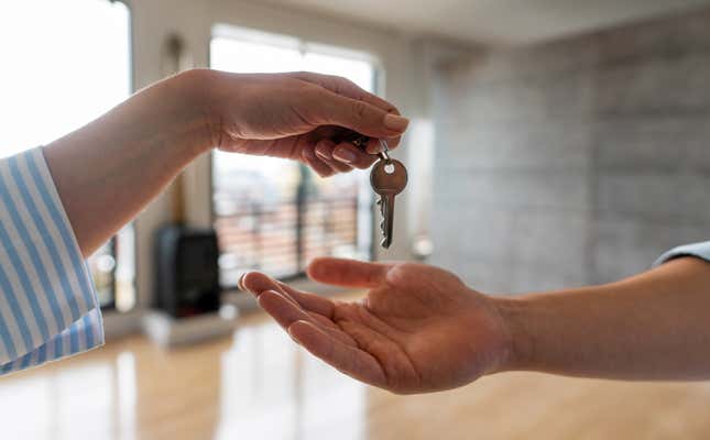 Real estate agent handing over the keys of a house