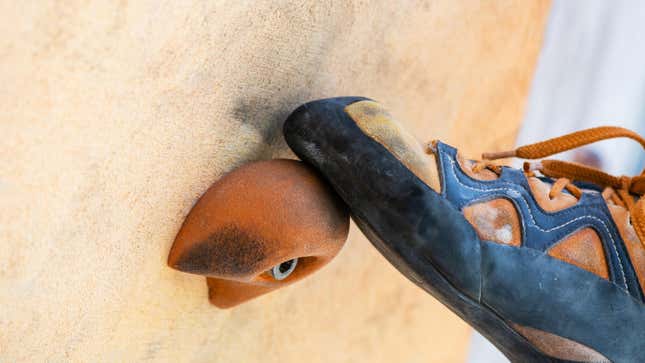 A close-up of a person’s climbing shoes.