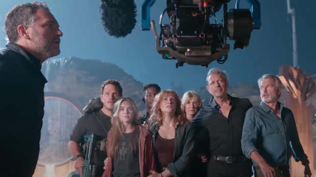 The director filming the casts of Jurassic park and world.