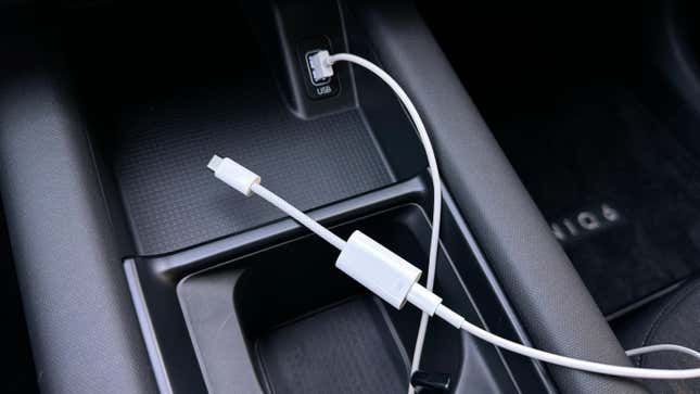 Detail view of a Hyundai Ioniq 6's center console with a charging cable plugged in