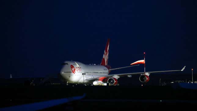 Virgin Orbit's 747 Cosmic Girl, with a 70 ft. rocket strapped below the wing. 